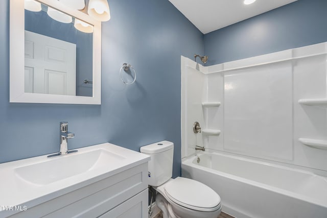 bathroom featuring toilet,  shower combination, and vanity