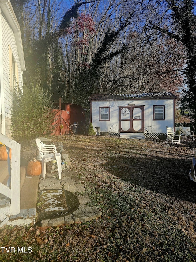 view of yard with an outbuilding and a patio area