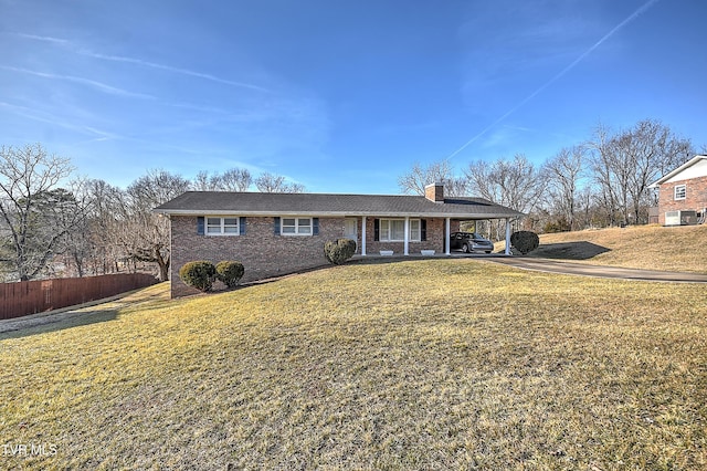 ranch-style house with a carport and a front lawn