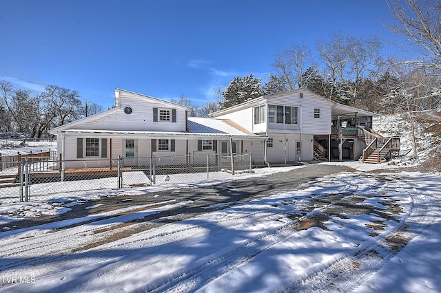 view of snow covered back of property