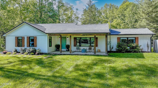 2912 W Walnut St, Johnson City, TN 37604 - back of property featuring a lawn, covered porch, and a shingled roof