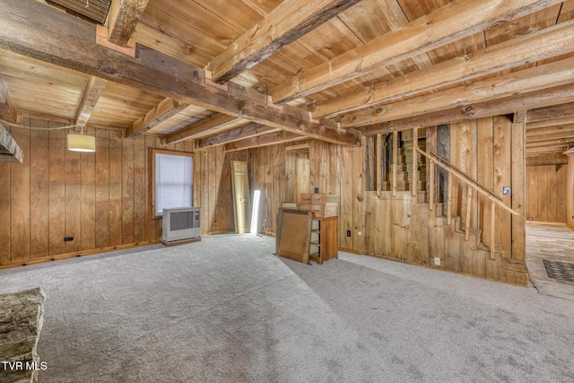 interior space featuring wood ceiling, carpet floors, and wood walls