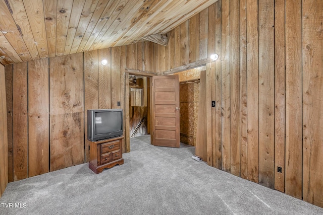 bonus room featuring wood ceiling, light colored carpet, and wood walls