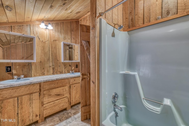 bathroom with vanity, wood ceiling, tub / shower combination, and wood walls