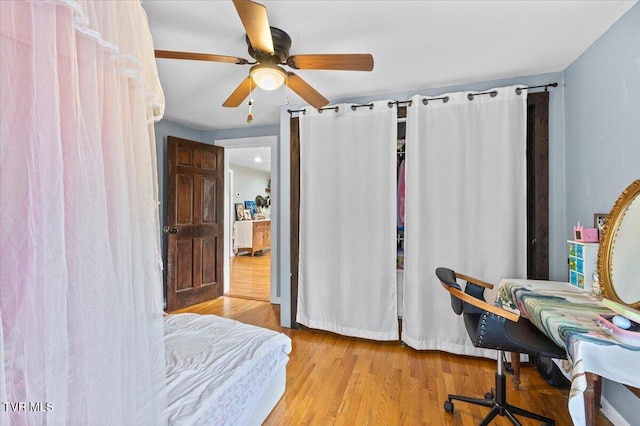 bedroom featuring ceiling fan and wood finished floors