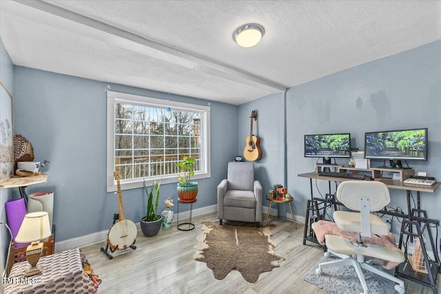 office with a textured ceiling, baseboards, and wood finished floors