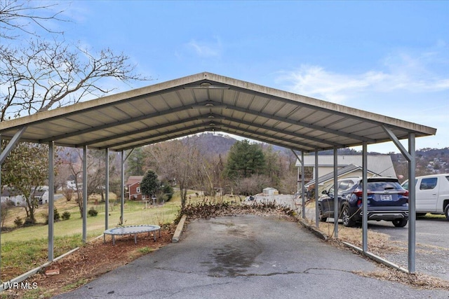 view of parking / parking lot with a carport