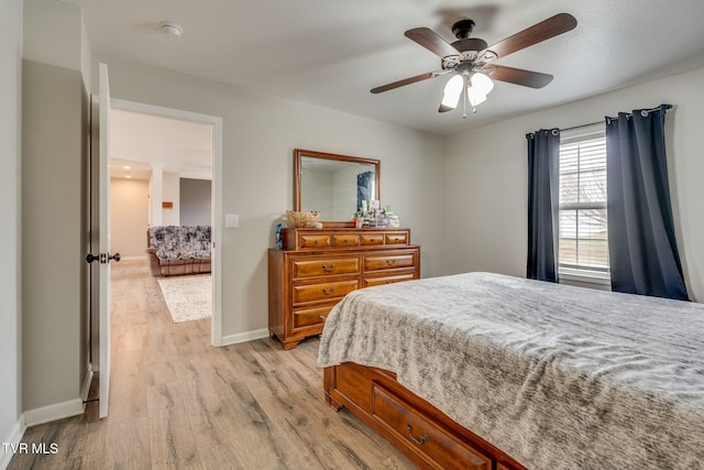 bedroom with ceiling fan and light hardwood / wood-style floors