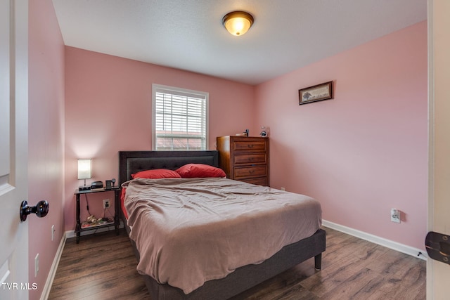 bedroom featuring dark hardwood / wood-style flooring