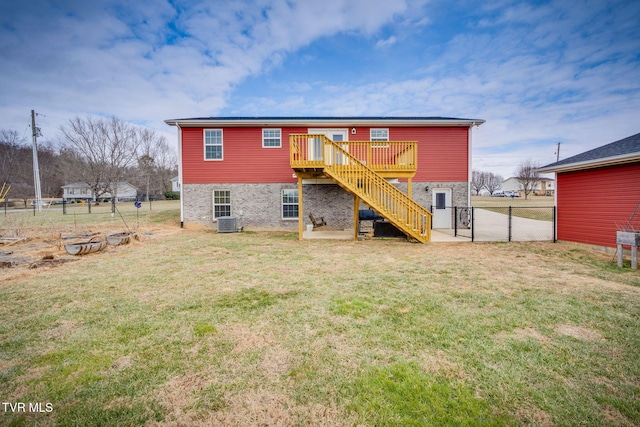 rear view of house featuring central AC unit, a yard, and a deck