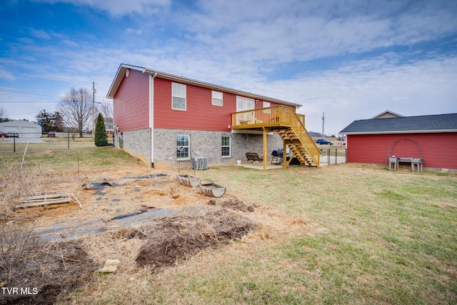 rear view of property with a wooden deck, a yard, and central air condition unit