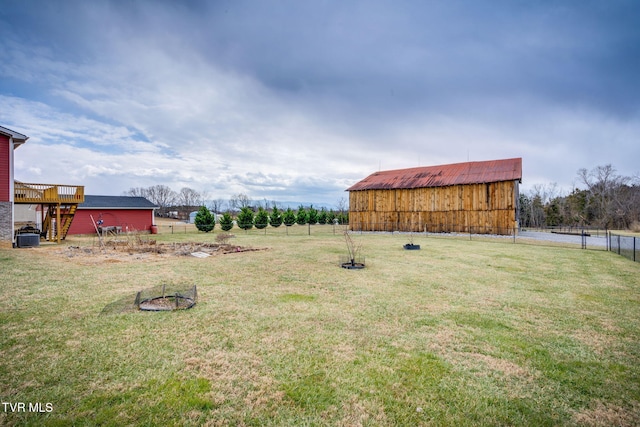 view of yard featuring central AC unit and an outbuilding