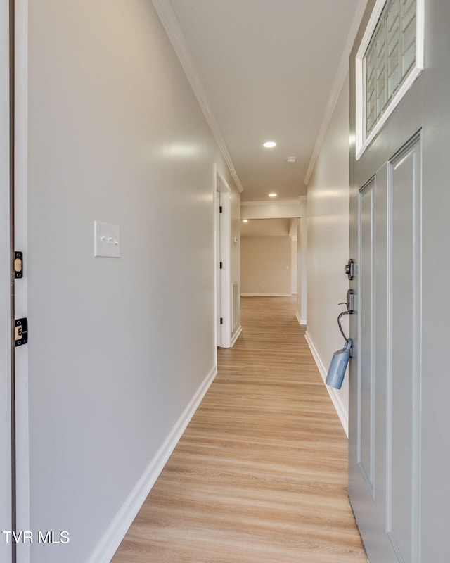 hall featuring light wood-type flooring and ornamental molding