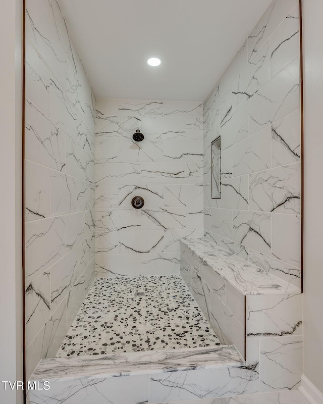 bathroom with a tile shower