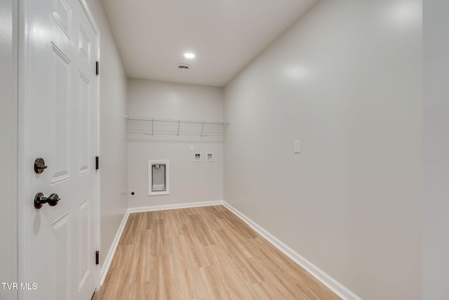 laundry area with hookup for an electric dryer, hookup for a washing machine, and light hardwood / wood-style flooring