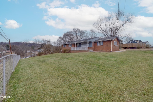 view of yard featuring covered porch