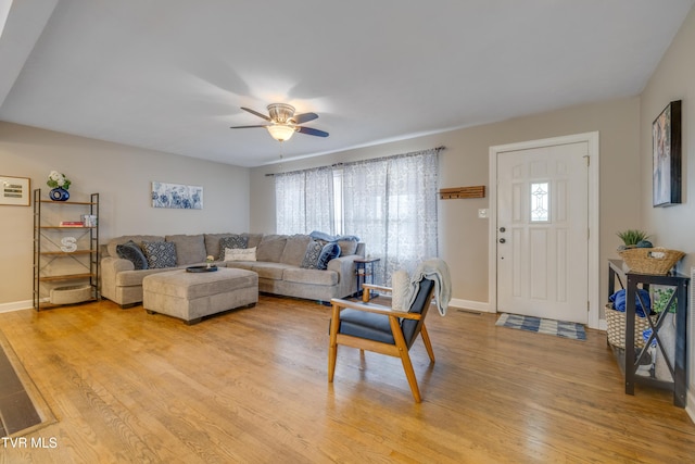 living room with ceiling fan and light wood-type flooring