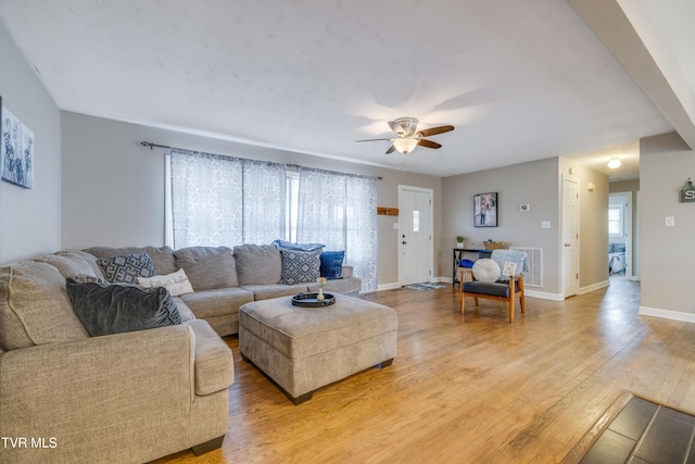 living room featuring light hardwood / wood-style flooring and ceiling fan