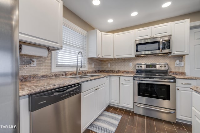 kitchen featuring stainless steel appliances, sink, and white cabinets