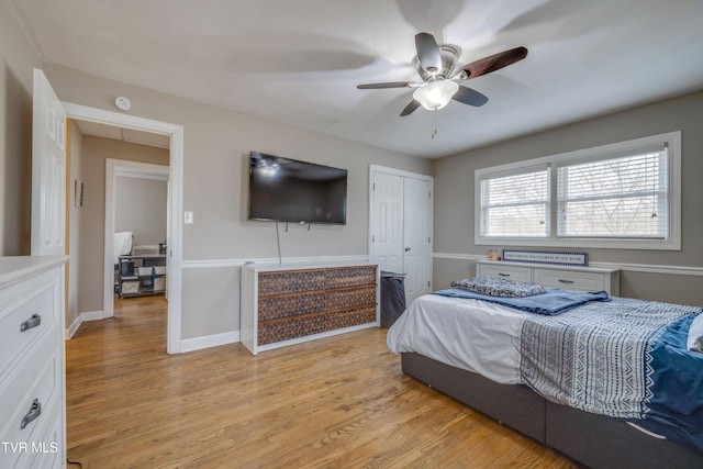 bedroom featuring light hardwood / wood-style flooring, a closet, and ceiling fan