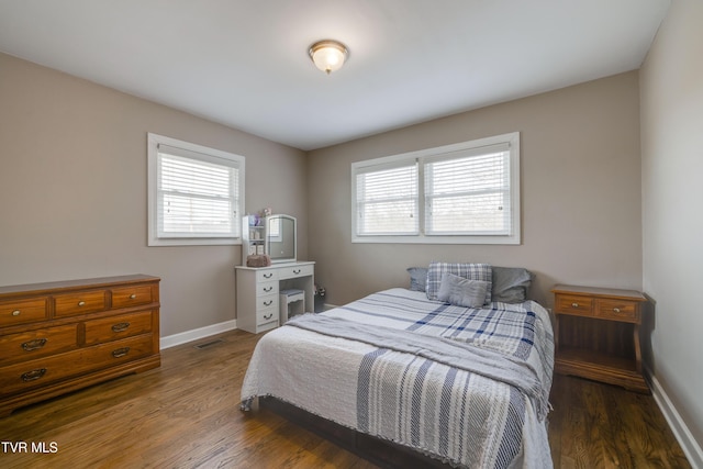 bedroom with dark hardwood / wood-style flooring