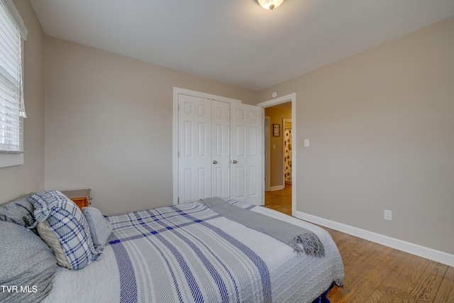 bedroom featuring hardwood / wood-style floors and a closet