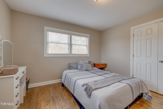 bedroom with a closet and light wood-type flooring