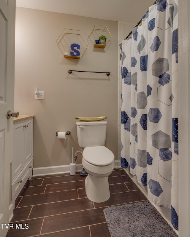 bathroom featuring vanity, a shower with curtain, and toilet