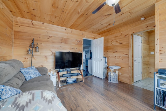 living room with hardwood / wood-style floors, wood ceiling, and wood walls