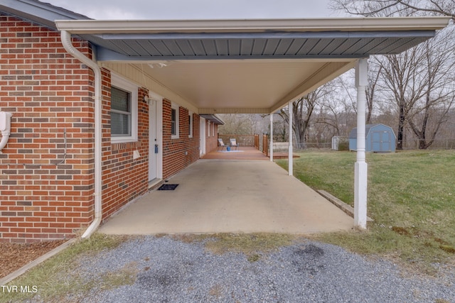 view of patio / terrace featuring a carport and a storage shed