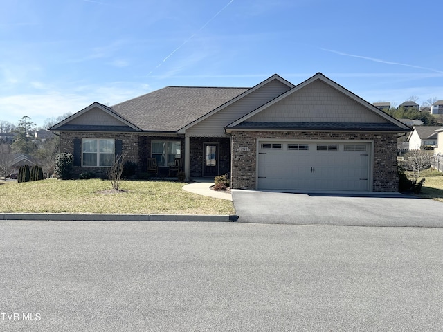 view of front of home featuring a garage and a front lawn