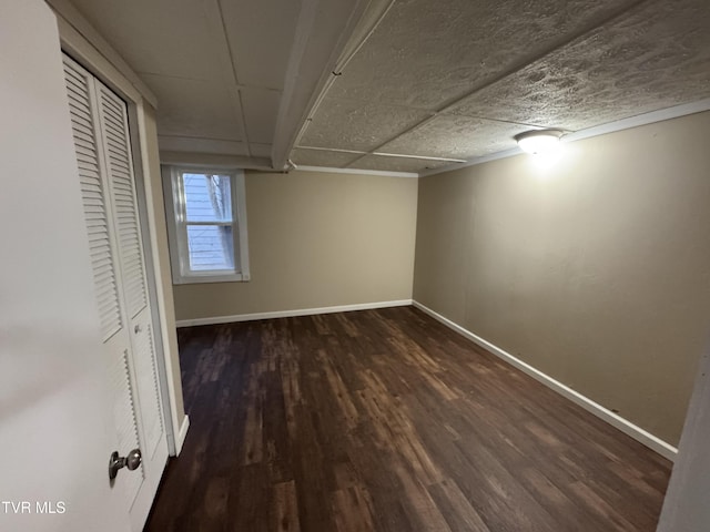 basement with dark hardwood / wood-style flooring