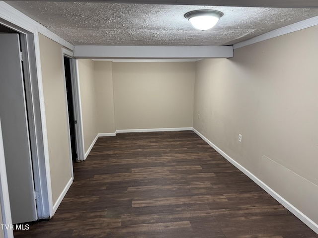 basement with dark wood-type flooring and a textured ceiling