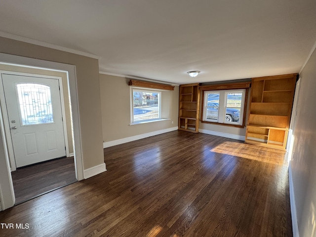 unfurnished living room featuring ornamental molding and dark hardwood / wood-style floors