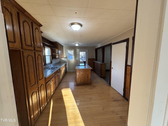 kitchen featuring dark hardwood / wood-style floors, a center island, and sink