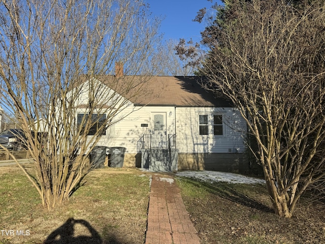 rear view of property with a lawn