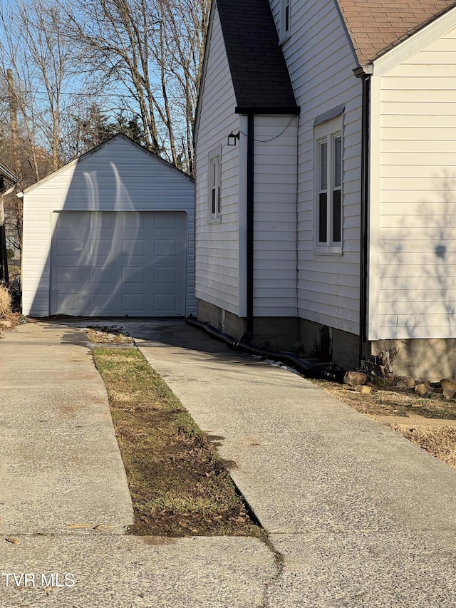 view of side of property featuring a garage and an outdoor structure