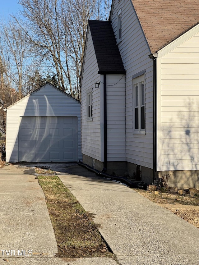 view of side of property featuring a garage and an outdoor structure