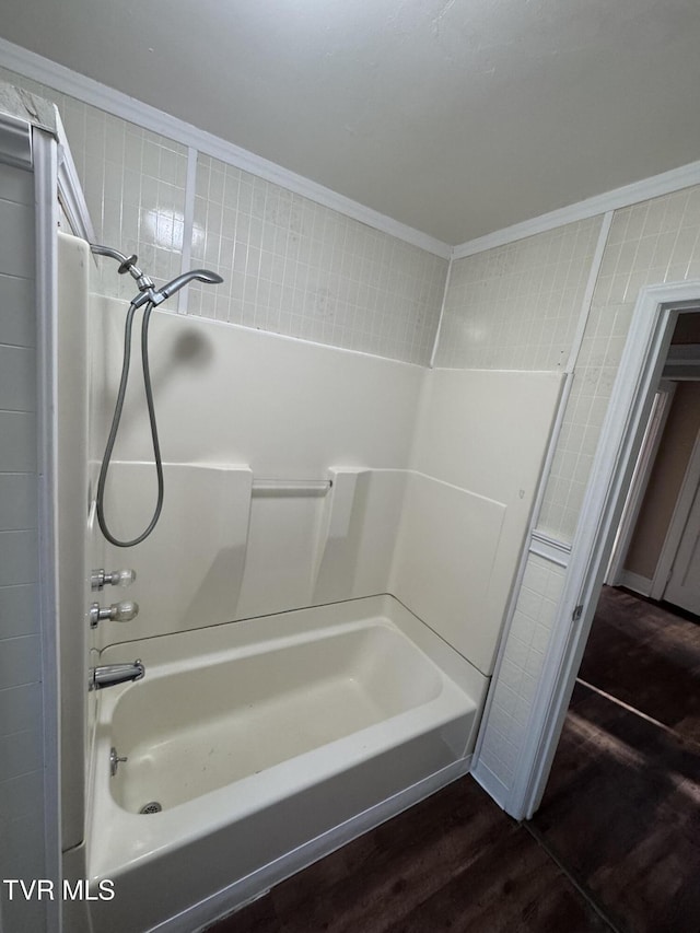 bathroom featuring hardwood / wood-style floors, ornamental molding, and  shower combination