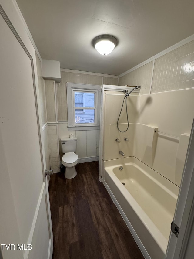 bathroom with hardwood / wood-style flooring, bathtub / shower combination, toilet, and crown molding