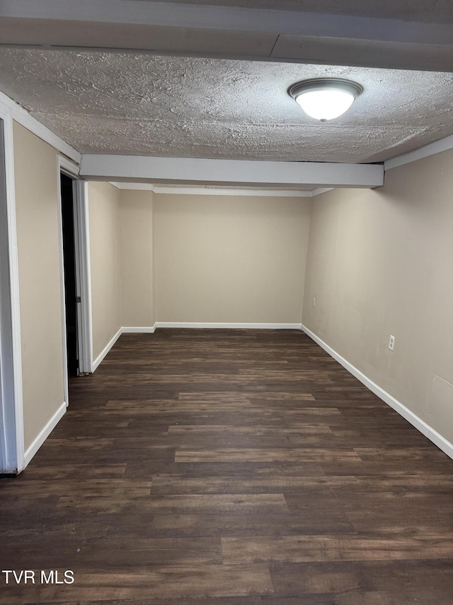 basement with dark hardwood / wood-style floors and a textured ceiling