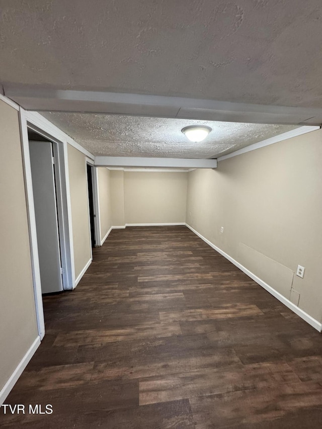 basement featuring dark hardwood / wood-style floors and a textured ceiling