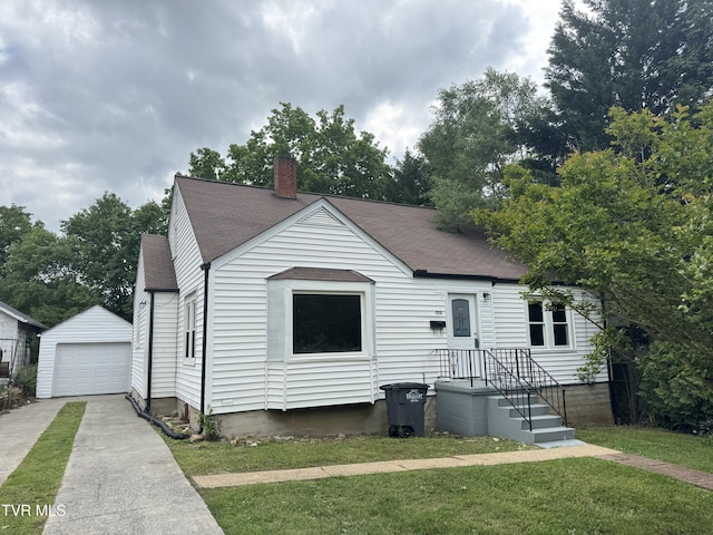 521 Elmwood Ave, Kingsport, TN 37660 - view of front of house featuring concrete driveway, a shingled roof, a chimney, a garage, and an outbuilding