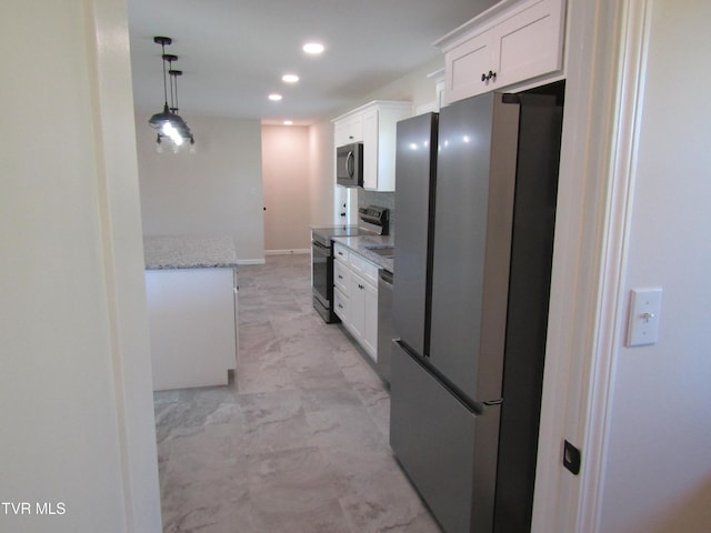 kitchen featuring hanging light fixtures, white cabinetry, light stone counters, and stainless steel appliances