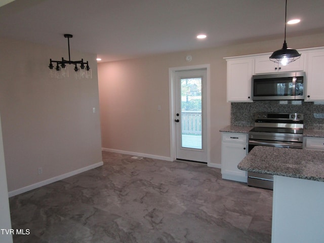 kitchen with tasteful backsplash, white cabinets, recessed lighting, appliances with stainless steel finishes, and hanging light fixtures