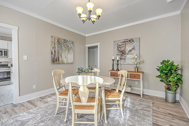 dining room featuring a notable chandelier, crown molding, and light wood-type flooring