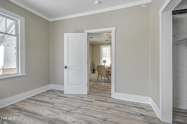 unfurnished bedroom featuring ornamental molding and light hardwood / wood-style floors