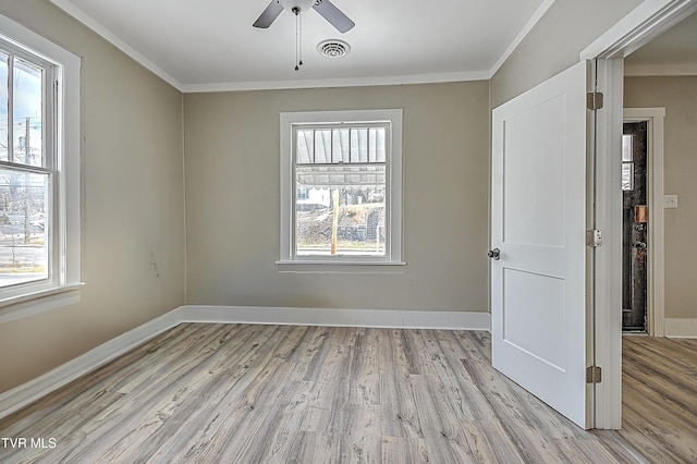 unfurnished room featuring ornamental molding, a healthy amount of sunlight, and light hardwood / wood-style flooring