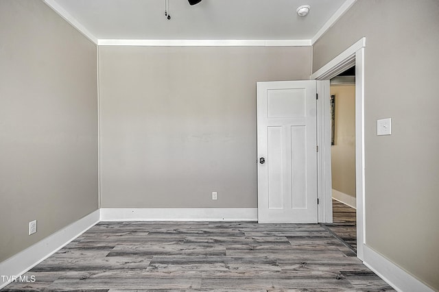 unfurnished room with wood-type flooring and ornamental molding