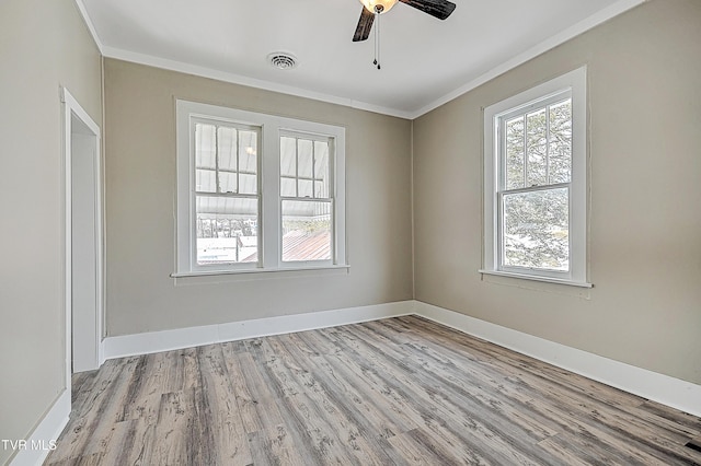 spare room with ornamental molding, ceiling fan, and light hardwood / wood-style floors